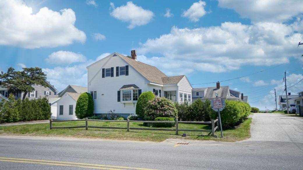 a white house on the side of a street at Hank's Hideaway by Bayley Vacation Rentals in Scarborough