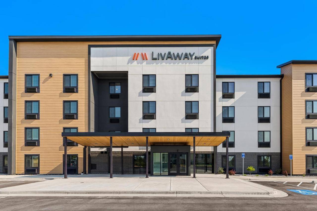 an image of an ivy hotel with a building at LivAway Suites Portland- Scarborough in Scarborough