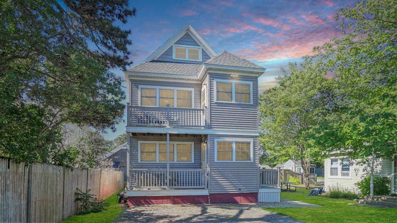 a blue house with a balcony on top of it at The Otis House by Bayley Vacation Rentals in Scarborough