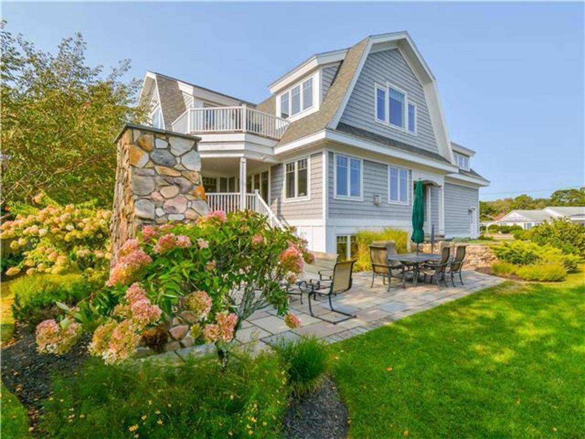a house with a patio and a table and chairs at Sea Breeze by Bayley Vacation Rentals in Scarborough