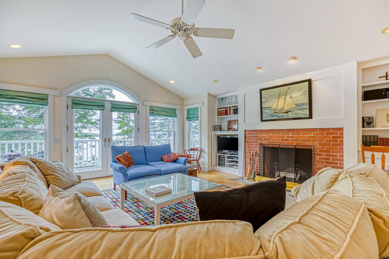 a living room with a couch and a fireplace at Compass Rose in Seal Cove
