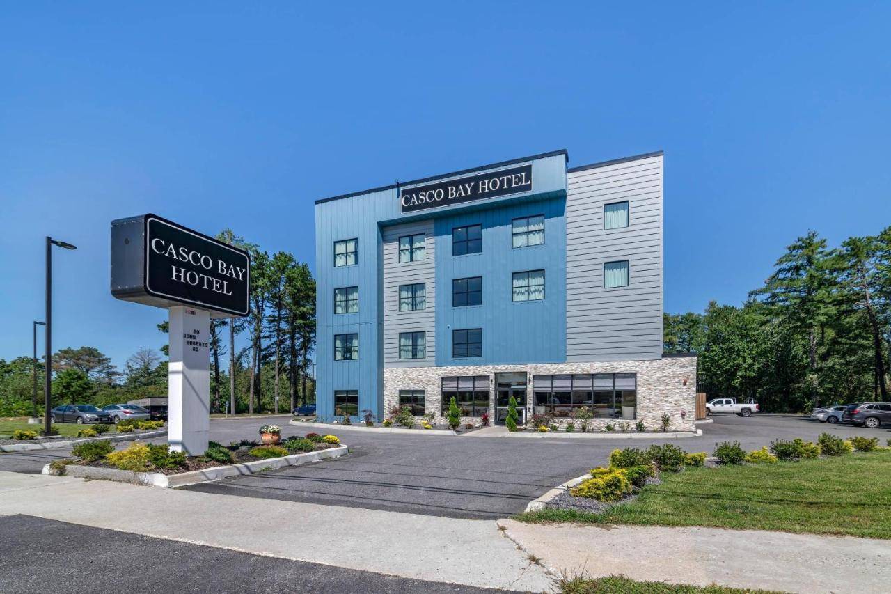 a building with a street sign in front of it at Casco Bay Hotel Portland Airport - Maine Mall, an Ascend Collection Hotel in South Portland