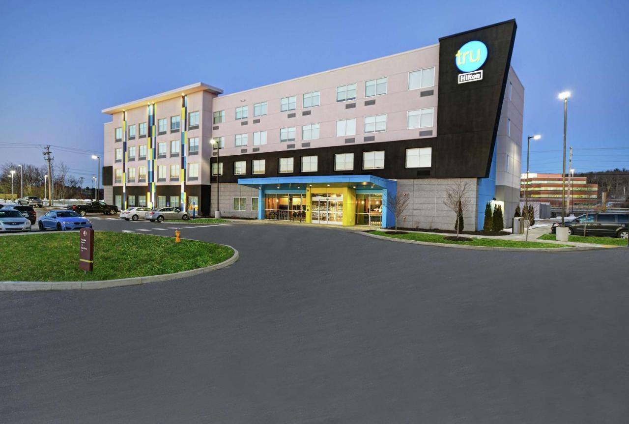 a large building with a car parked in a parking lot at Tru By Hilton Portland Airport Area Me in South Portland
