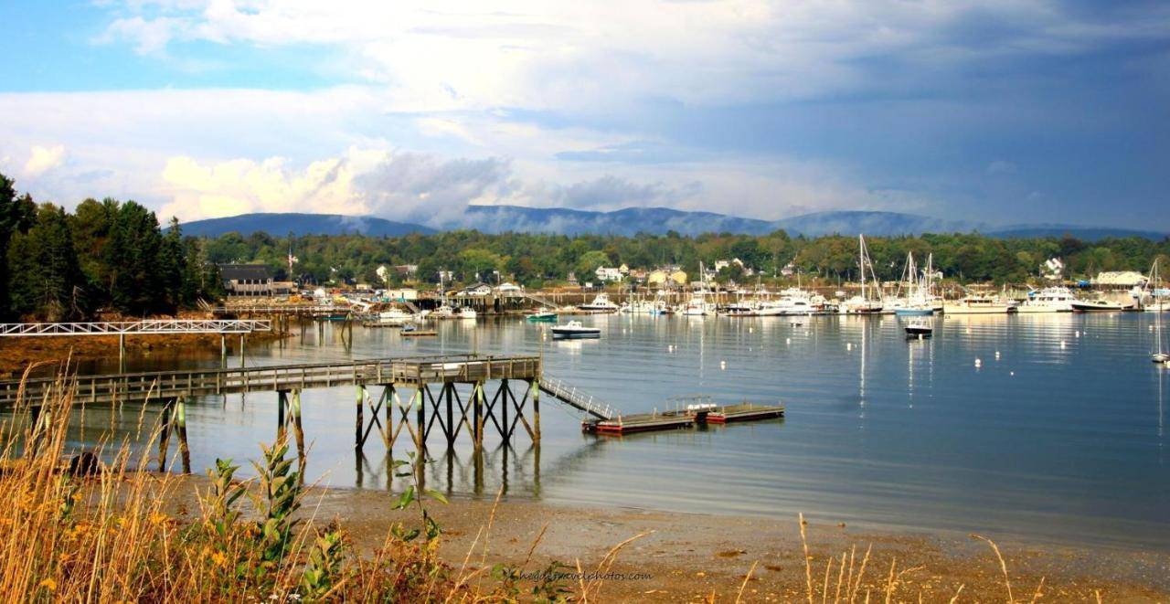 a marina with boats in the water on a cloudy day at Acadia II on the Harbor in Southwest Harbor