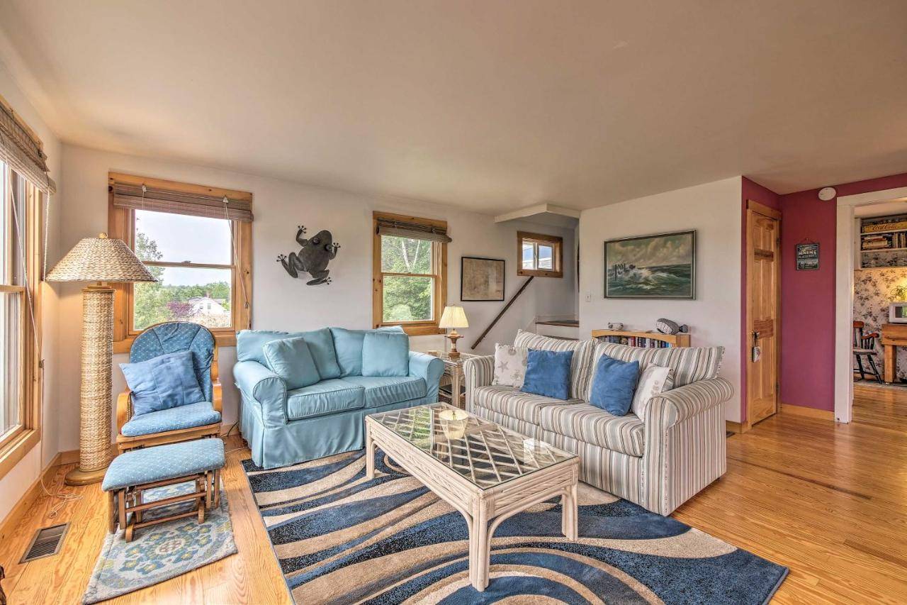 a living room with two couches and a coffee table at Acadia National Park Home with Deck and Ocean View! in Southwest Harbor