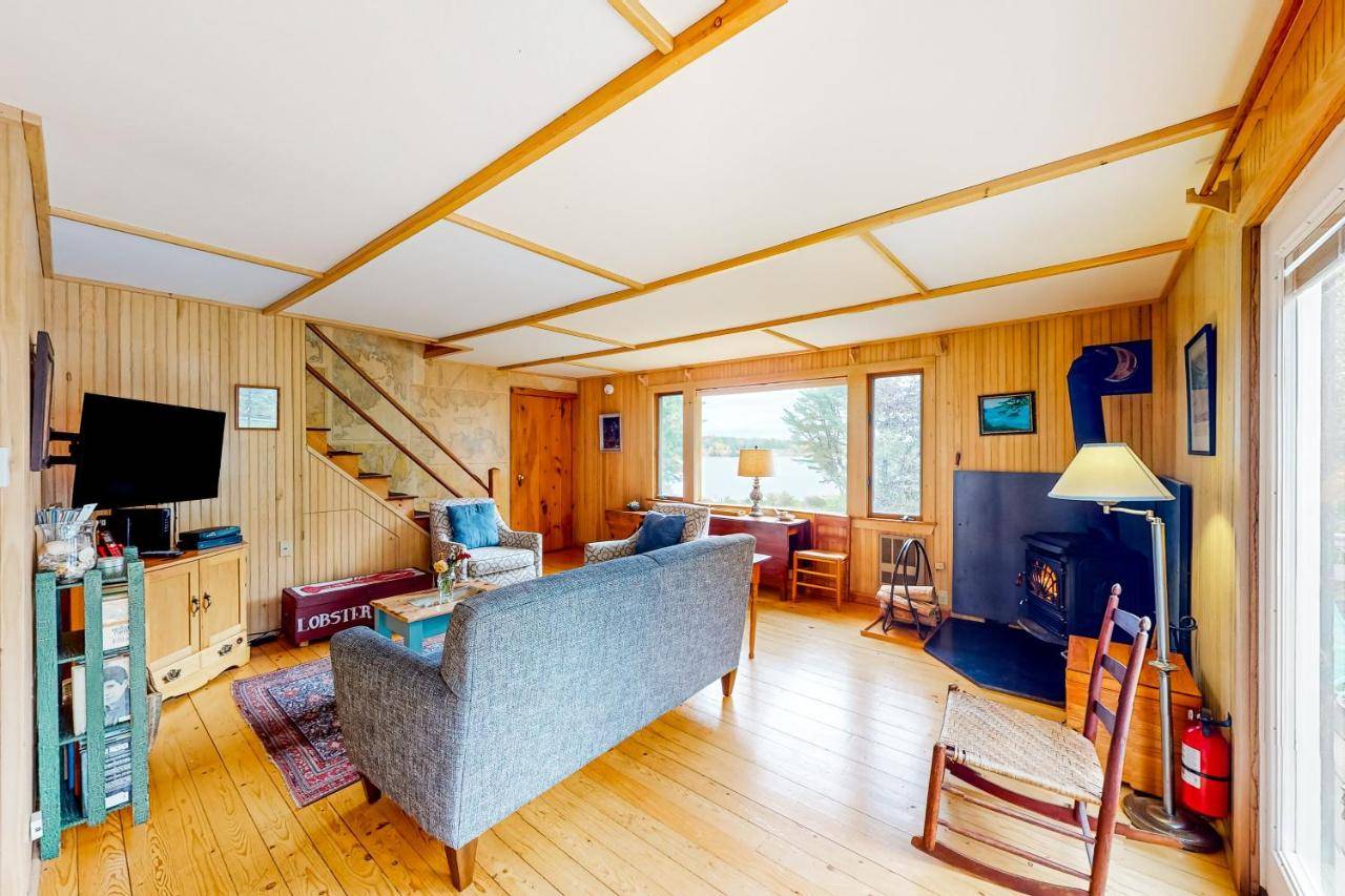a living room with a couch and a television at Cobb Nob Compound in Southwest Harbor