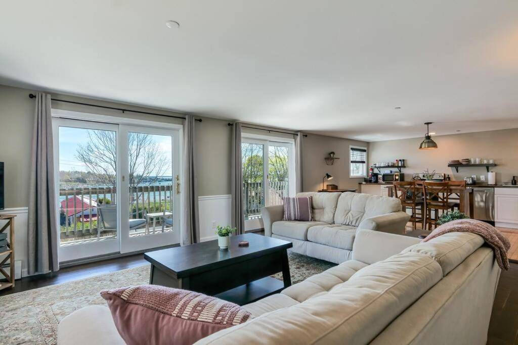 a living room with a couch and a table at 2BR Condo with Ocean Views in Downtown SW Harbor "Seaglass" in Southwest Harbor