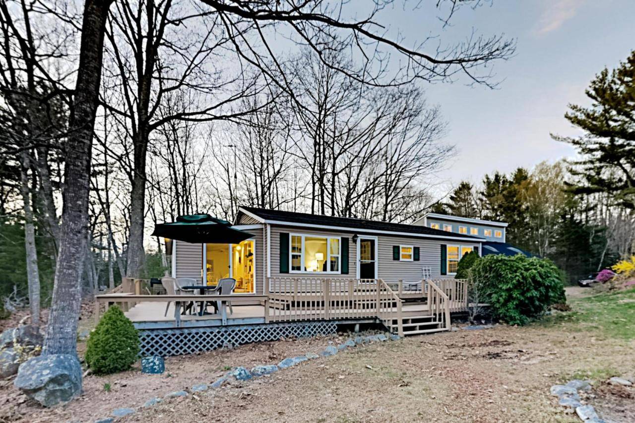 a tiny house in the woods with a porch at Mariner's Reach in Sullivan