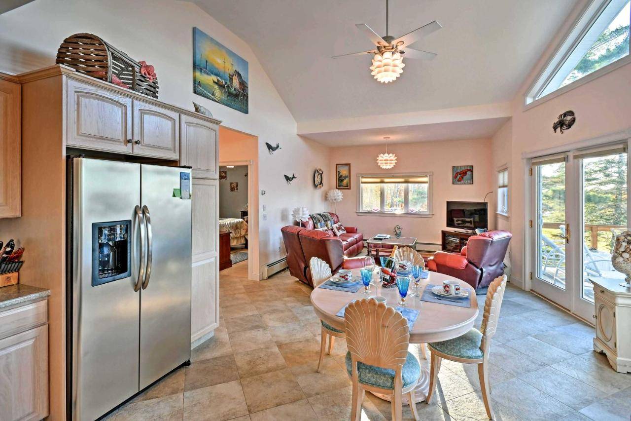 a kitchen and living room with a table and chairs at Oceanfront Sullivan Cottage on 6 Acres with Kayak! in Sullivan