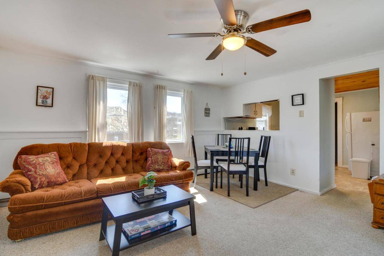 a living room with a couch and a table at Oakland Apt on Messalonskee Lake with Dock Access! in Waterville