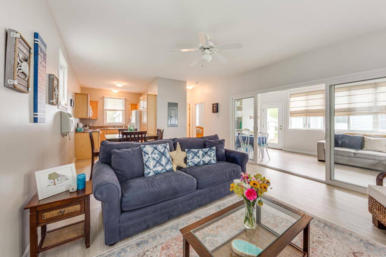 a living room with a blue couch and a table at 1 Mi to Moody Beach Cottage with Pool Access! in Wells