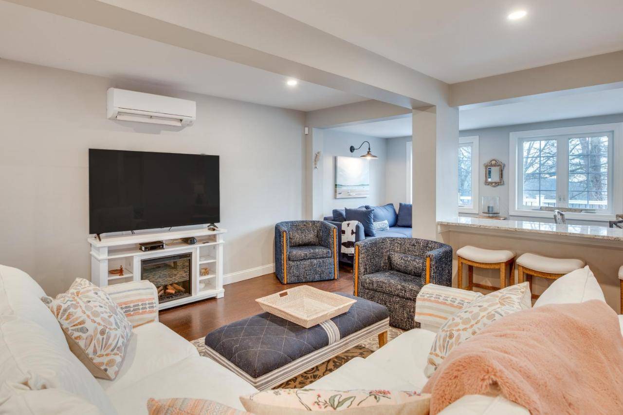 a living room with a couch and a tv at 1 Mi to Drakes Island Beach Cottage with Deck! in Wells