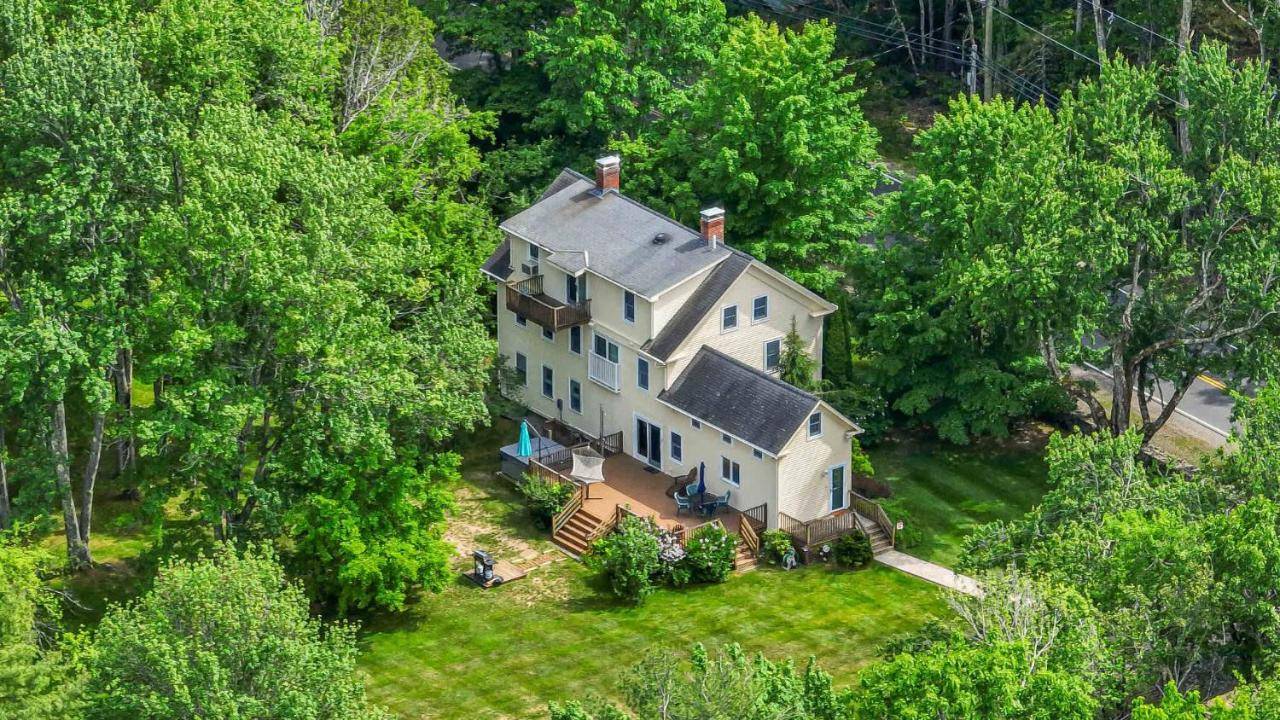 an aerial view of a large house in the woods at 4 BDR with Private Hot tub Backyard and Deck in Wells