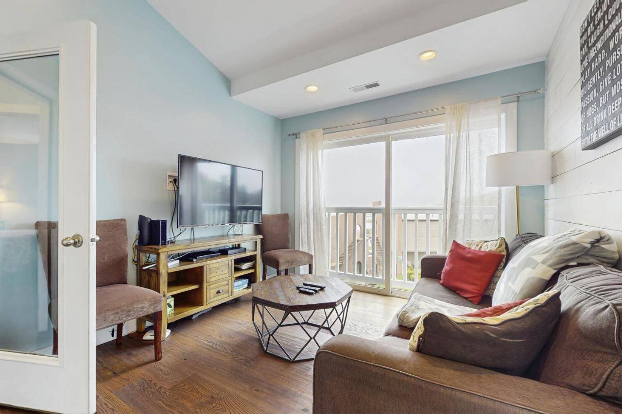 a living room with a couch and a tv at Bay Breeze in Wells