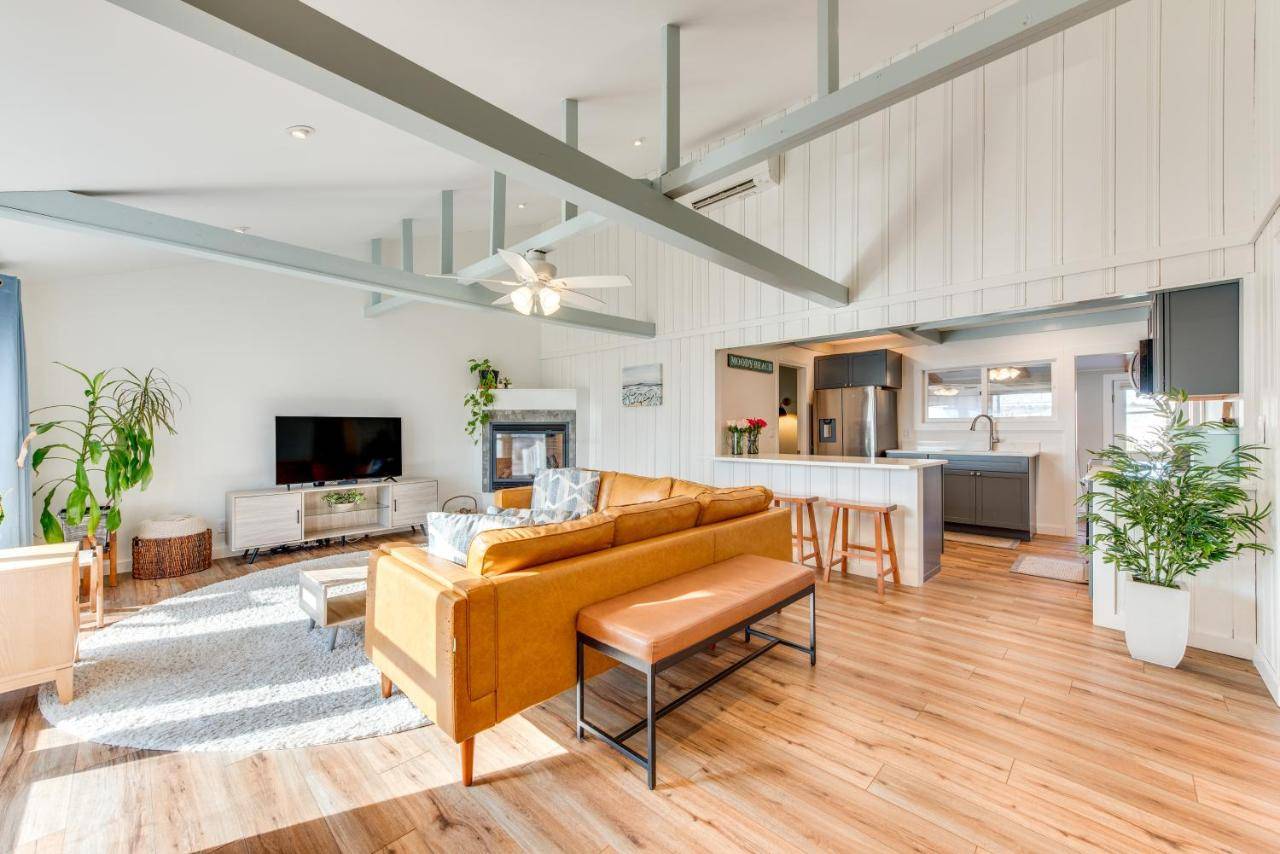 a living room with a couch and a kitchen at Beautiful Wells Cottage Steps to Moody Beach! in Wells
