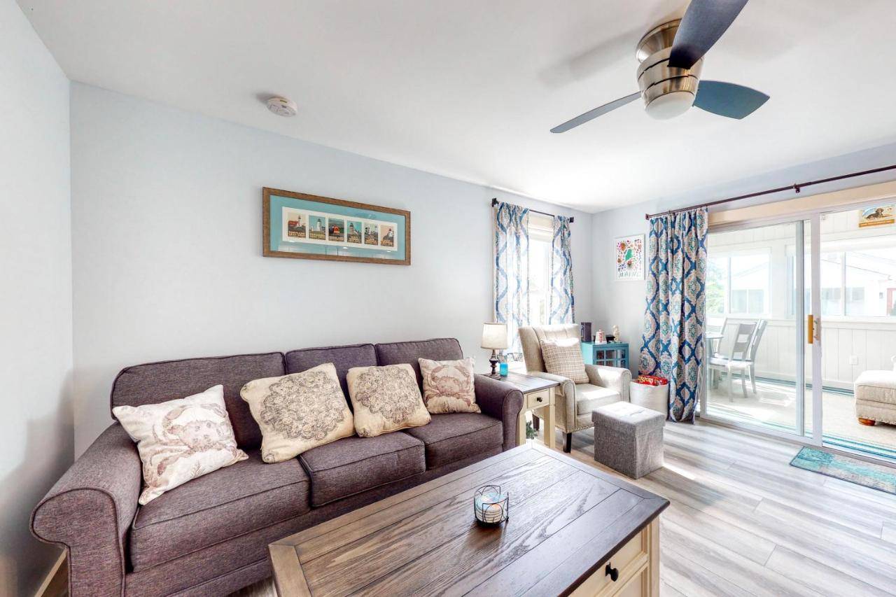 a living room with a couch and a table at Belle of Maine Cottage 33 - Piper's Landing in Wells