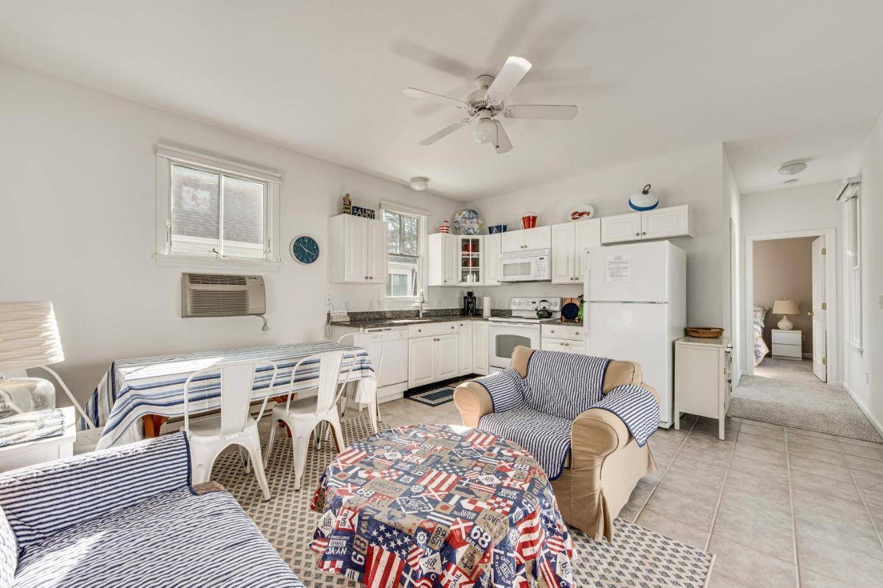 a kitchen with white cabinets and a table and chairs at Cozy Wells Cottage with Pool Access 1 Mi to Beach! in Wells