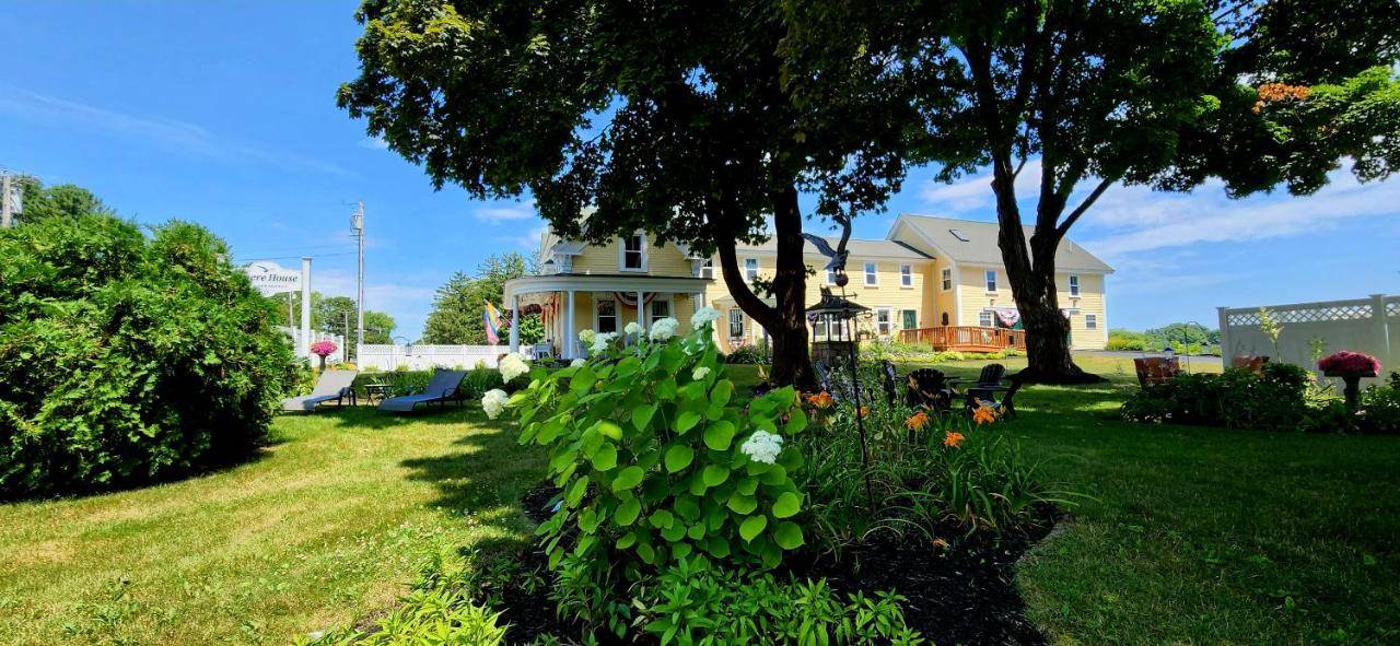 a house with a yard with flowers in the grass at Elmere House Bed & Breakfast in Wells