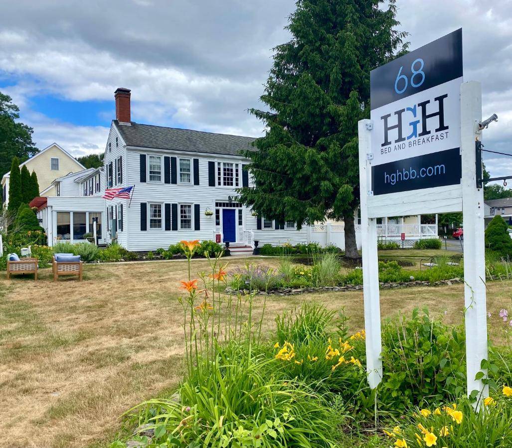 a sign in front of a white house at Holiday Guest House Bed & Breakfast in Wells