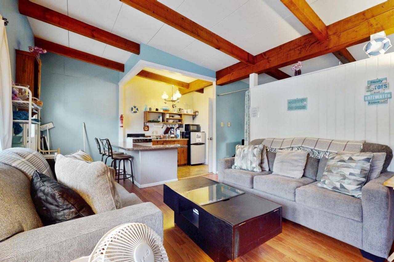 a living room with two couches and a table at Sandy Toes Escape - Holiday House M6 in Wells