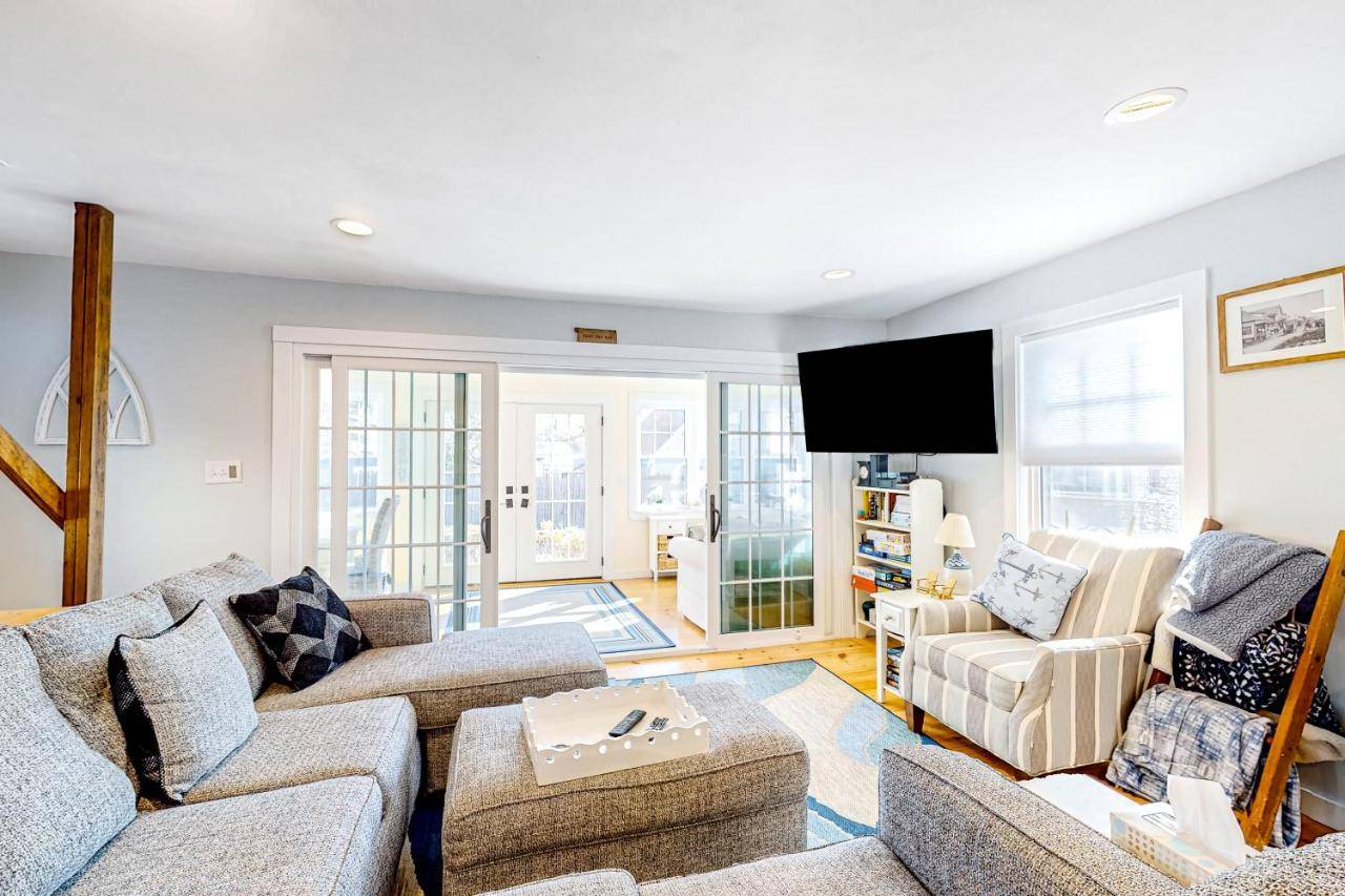a living room with couches and a flat screen tv at Seas the Day in Wells