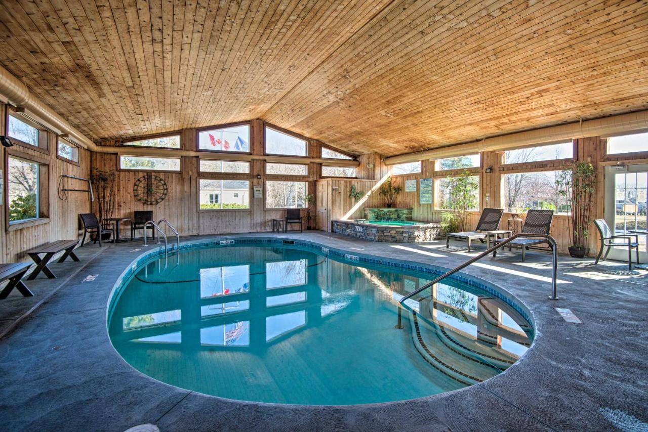 a swimming pool in a house with a wooden ceiling at Southern Maine Retreat Less Than 2 Mi to Wells Beach! in Wells