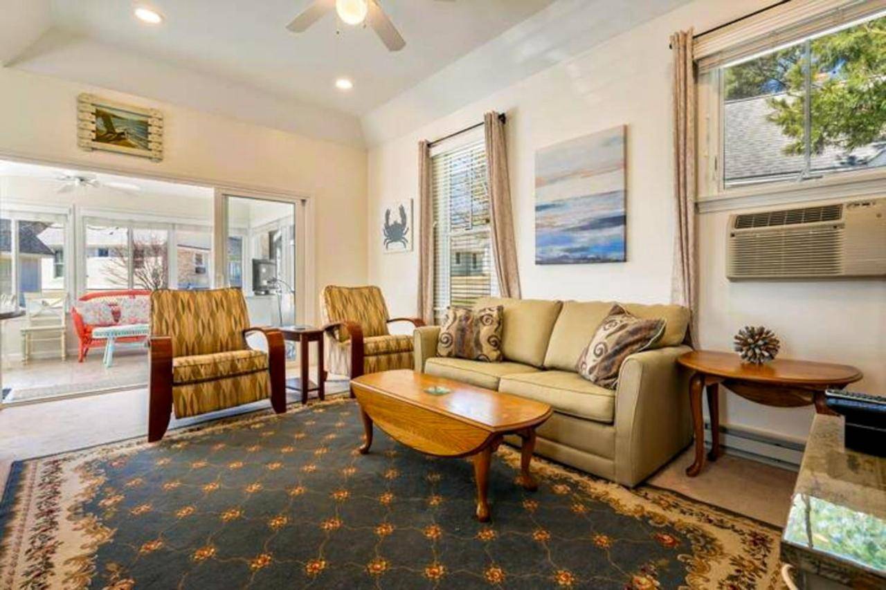 a living room with a couch and a table at Summer Village Cottage in Wells