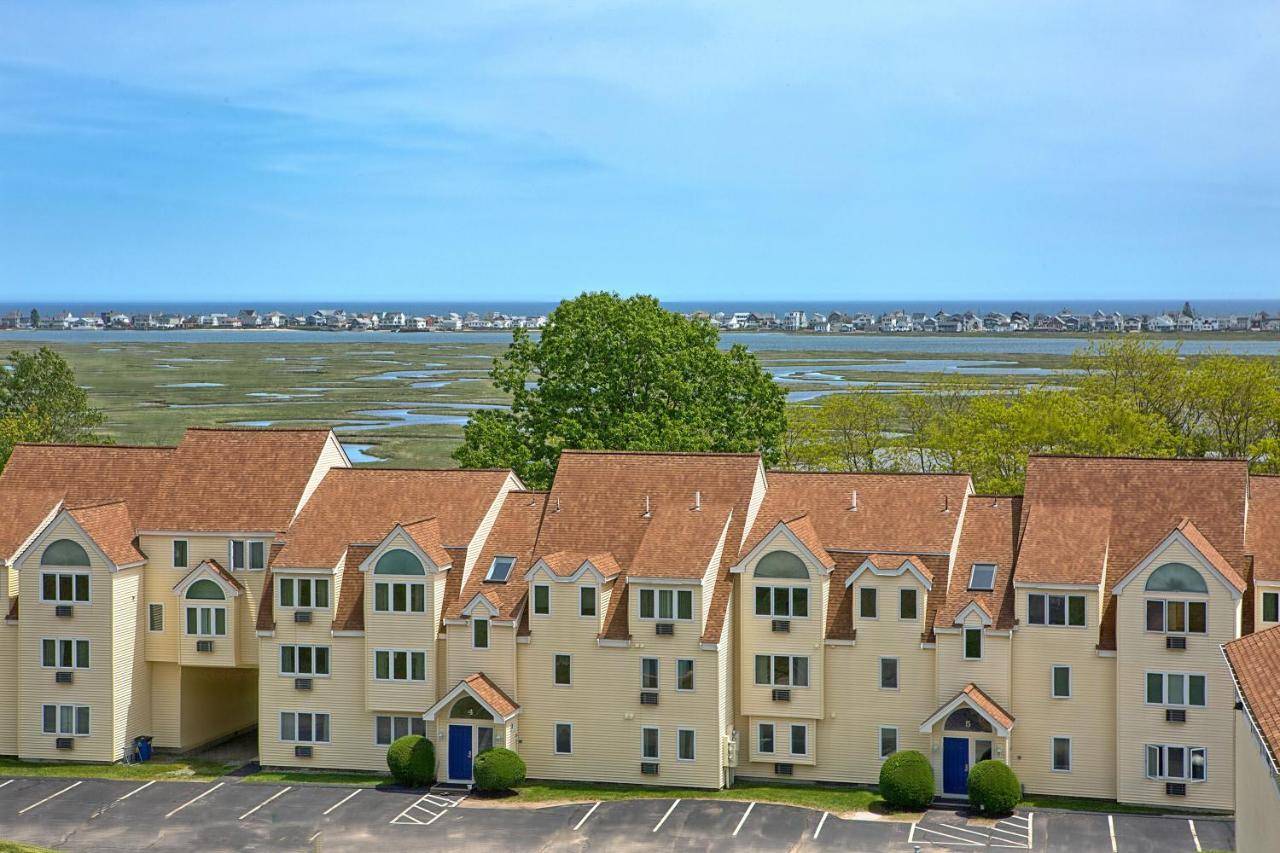 an aerial view of a building with roofs at Village By The Sea in Wells