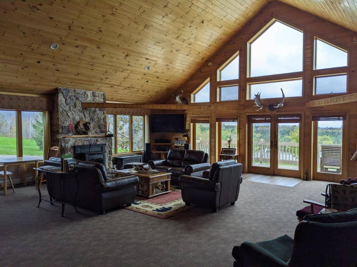 a living room with couches and a fireplace at First Settlers Lodge in Weston