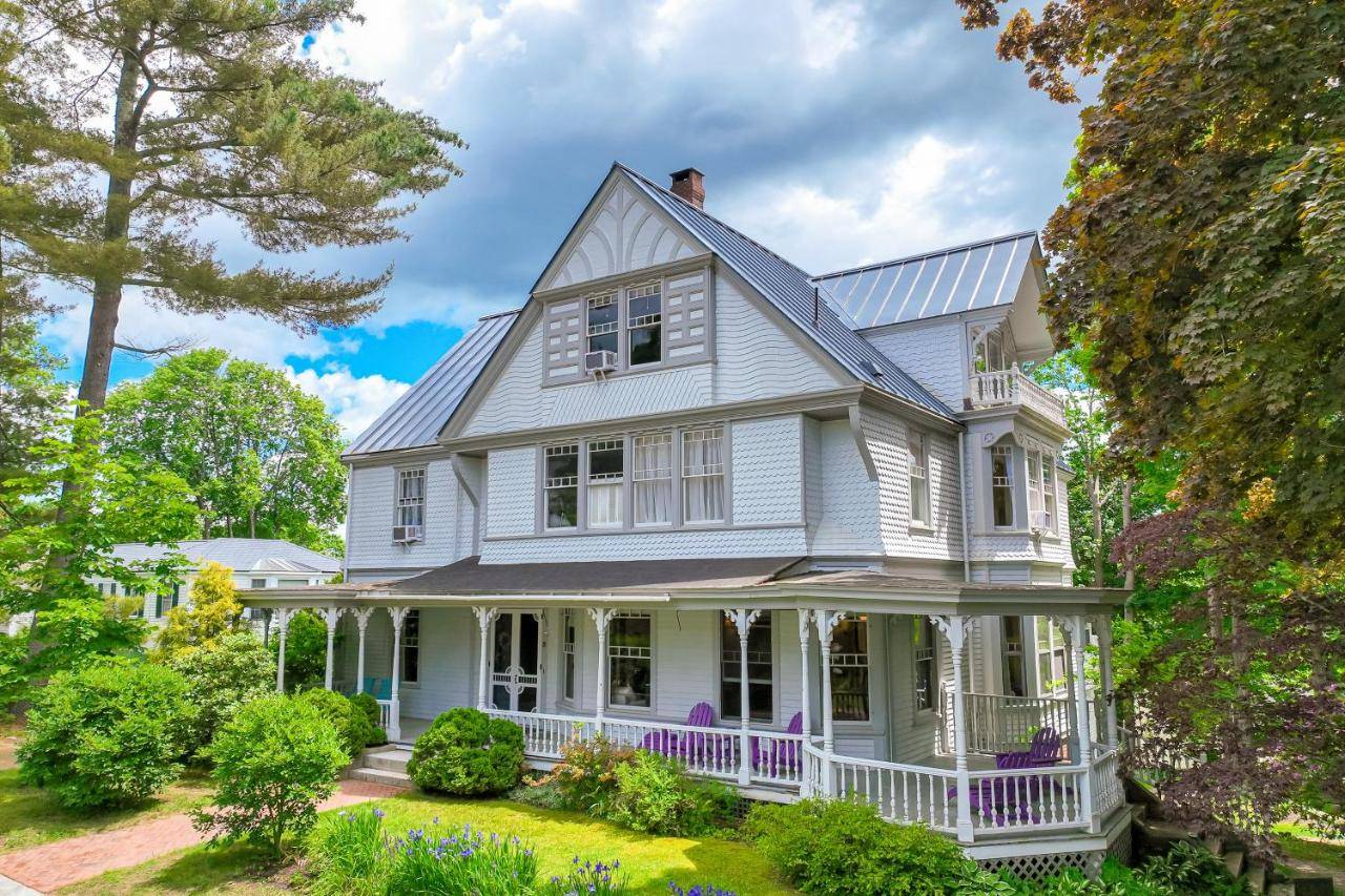 a white house with a porch at High Street Stunner in Wiscasset