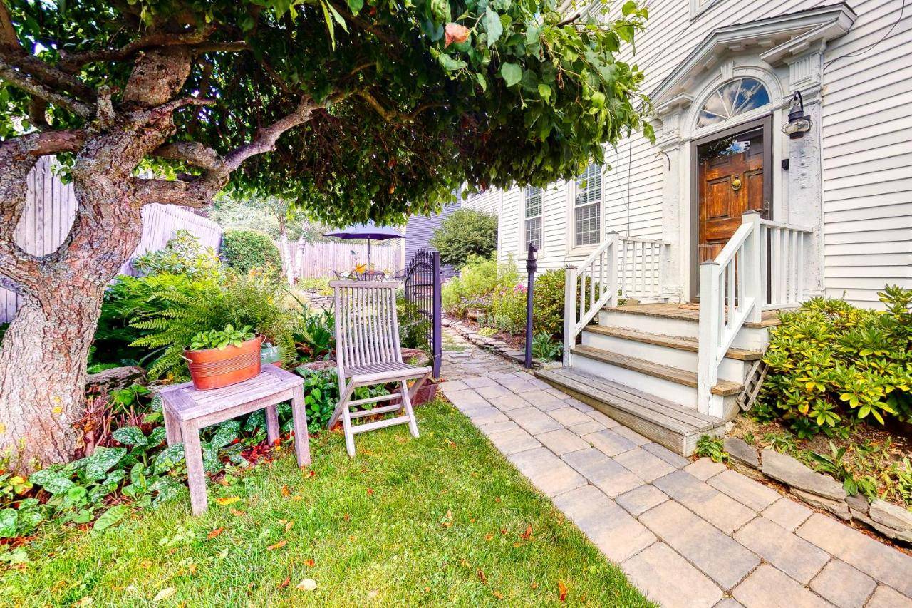 a yard with a chair and a table and a tree at Maine Memories in Wiscasset