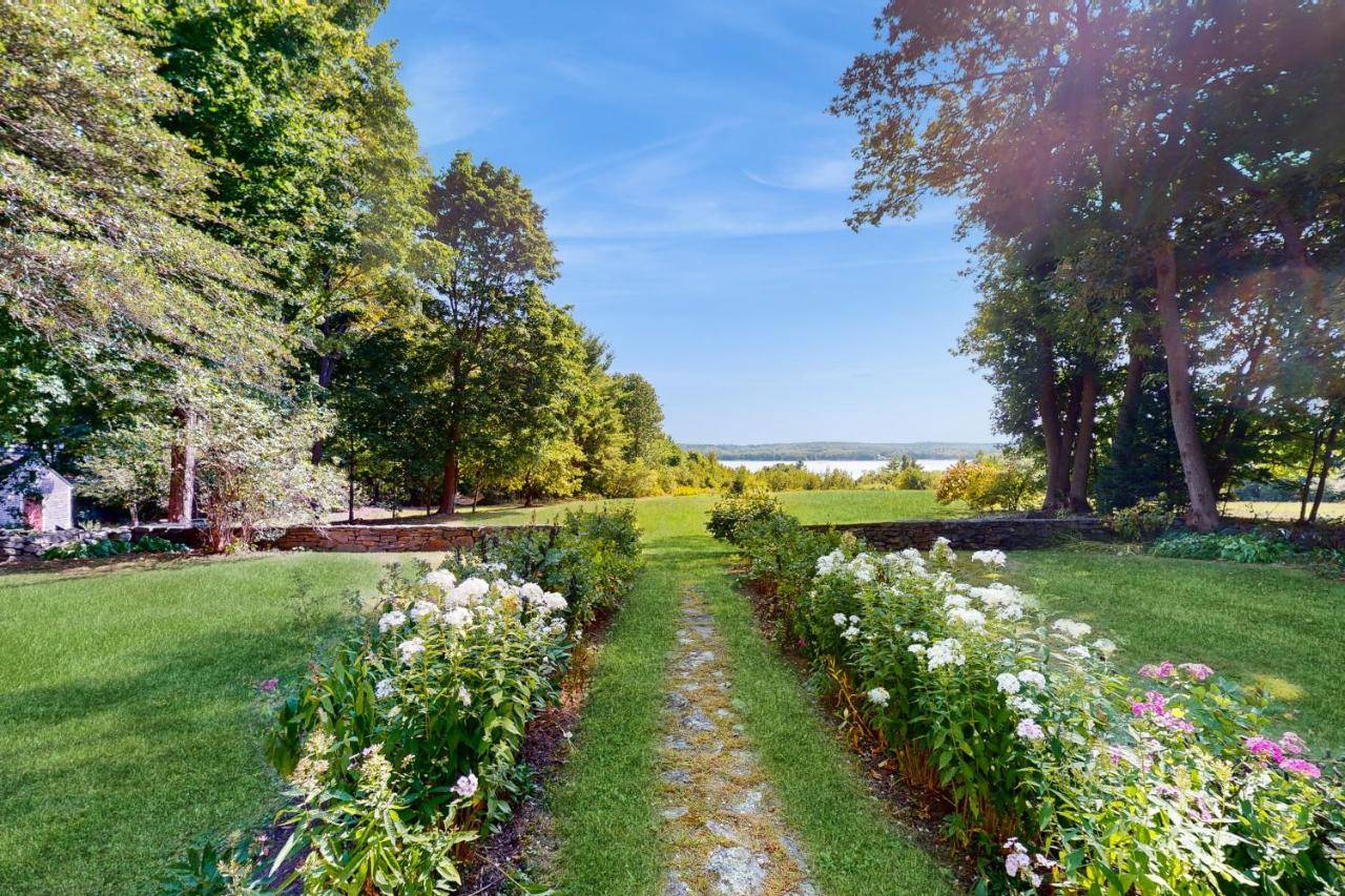 a garden with flowers in the middle of a field at The Rice Andrews House circa 1762 in Wiscasset