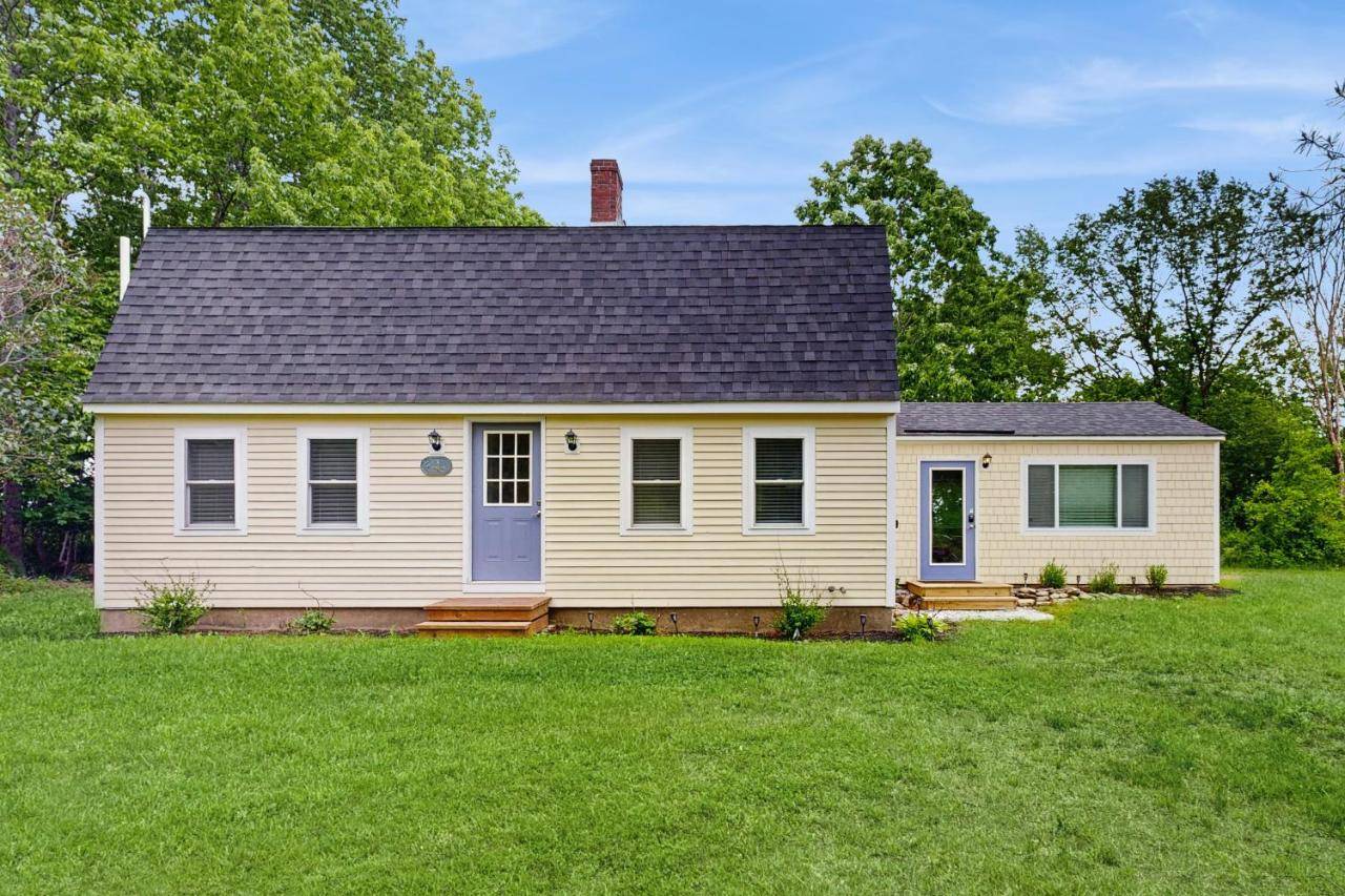 a small white house with a large yard at Wiscasset Woodland Haven in Wiscasset