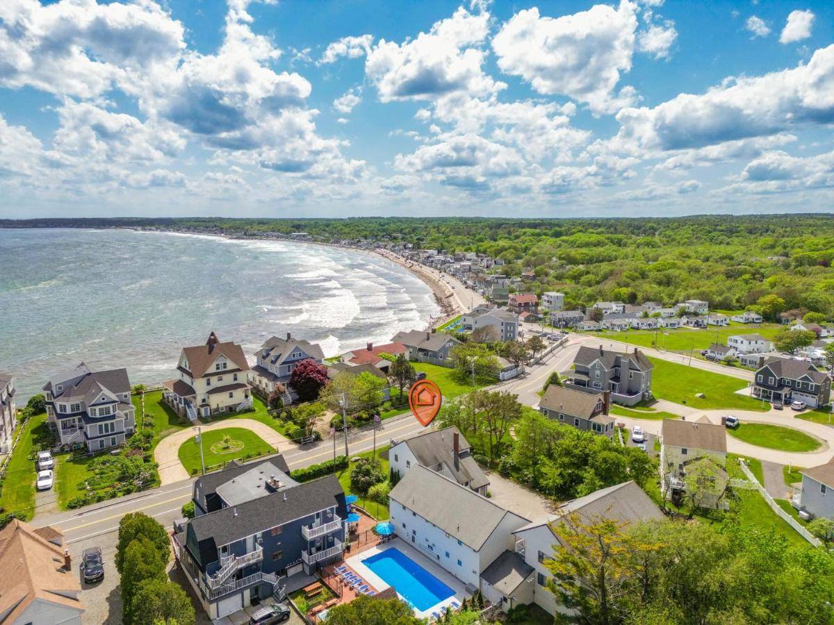 an aerial view of a beach with houses and condos at The Lighthouse Inn & Suites in York Beach