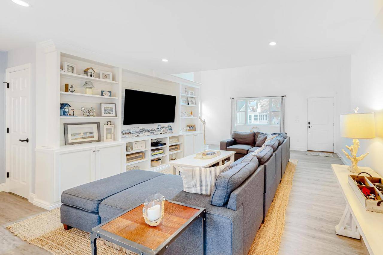 a living room with a couch and a tv at Coastal Gem in York