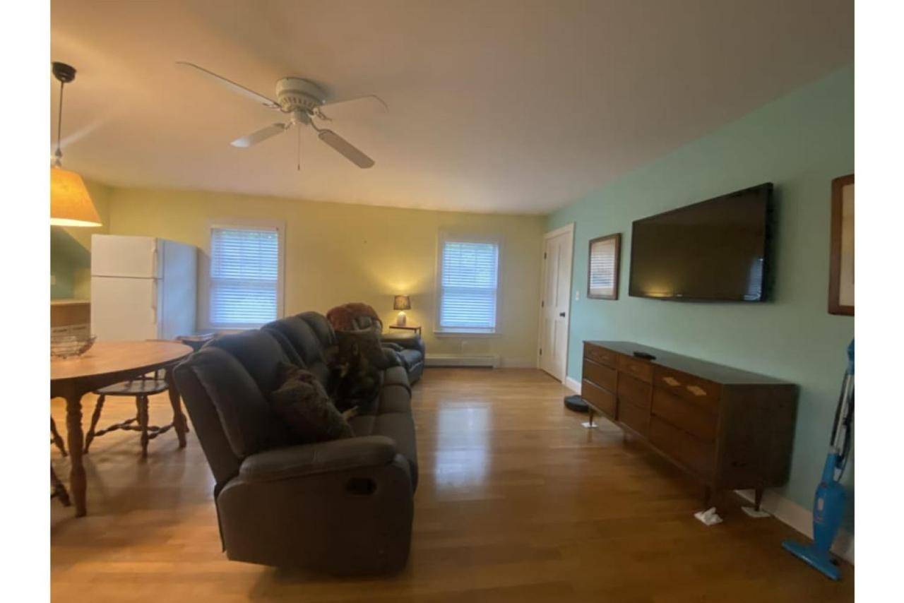 a living room with a couch and a flat screen tv at Cozy In-Law Suite Near York Beaches in York