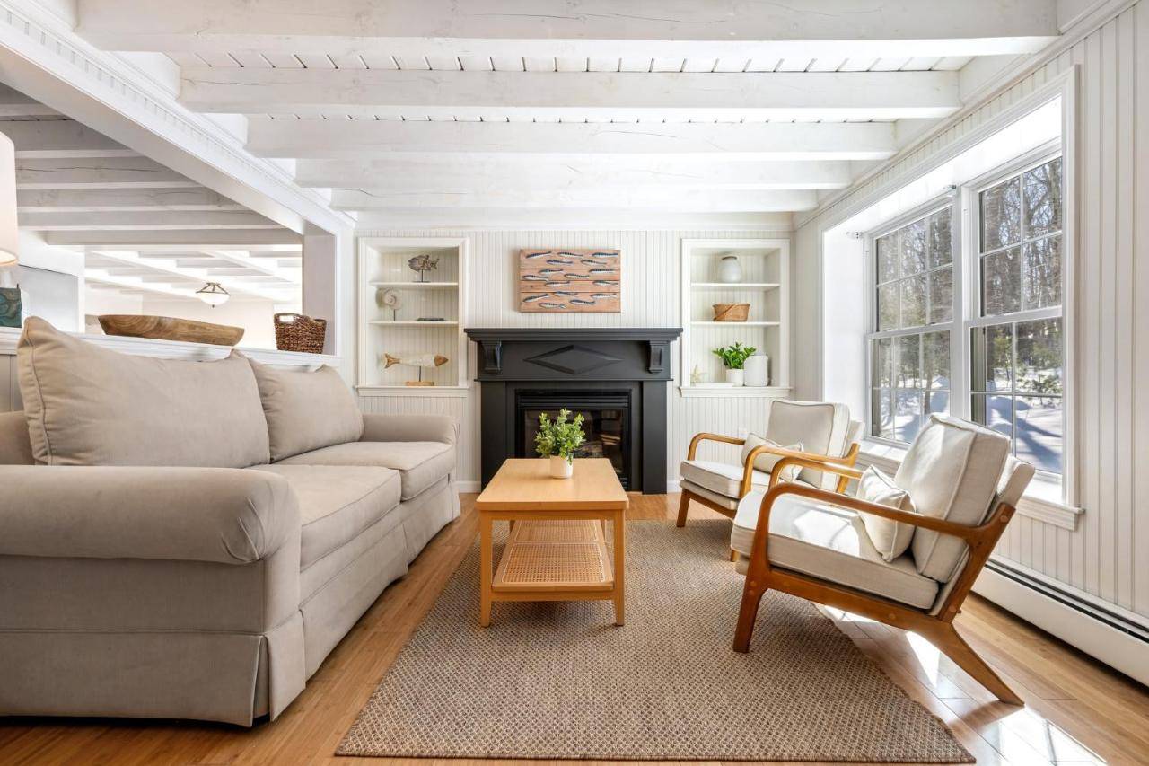 a living room with a couch and a fireplace at Good Tidings Stay for 8 in York