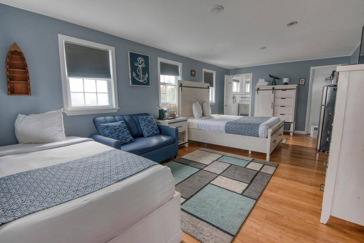 a bedroom with two beds and a blue wall at Sea Turn Motel in York