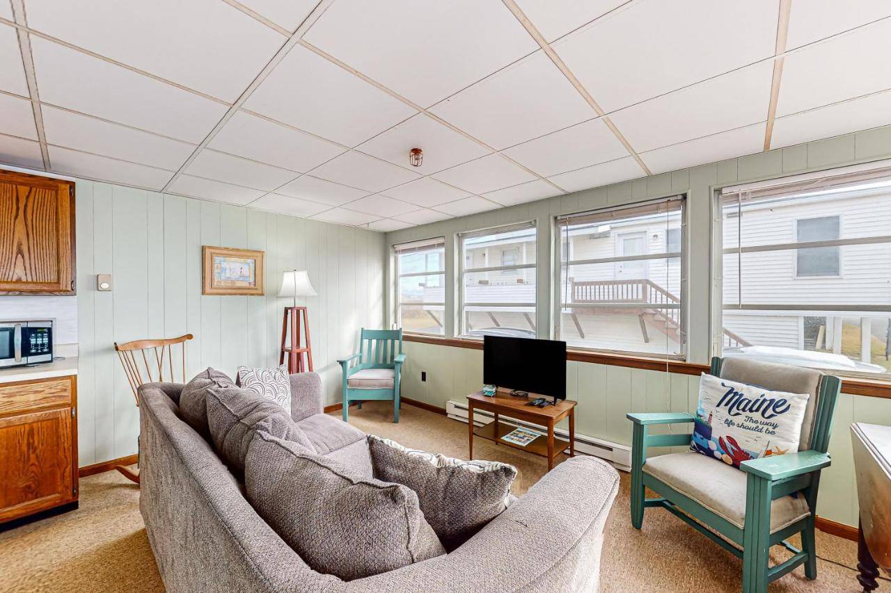 a living room with two couches and a tv at Seafoam Dreams in York