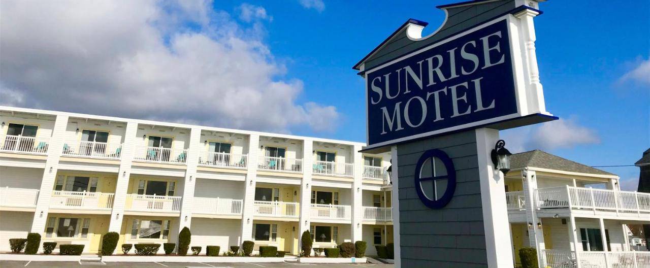 a hotel with a clock in front of a building at Sunrise Motel in York