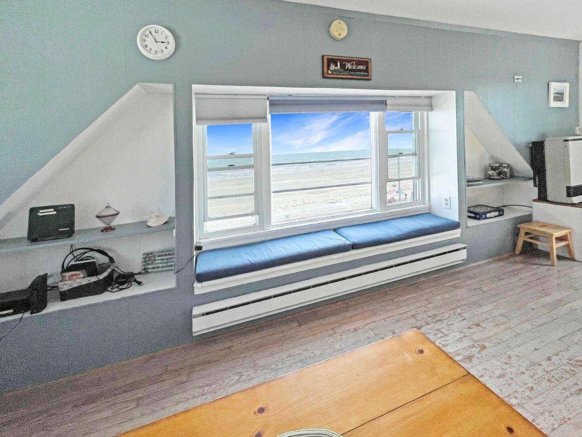 a room with a window with a view of the beach at Sweet Serenity in York