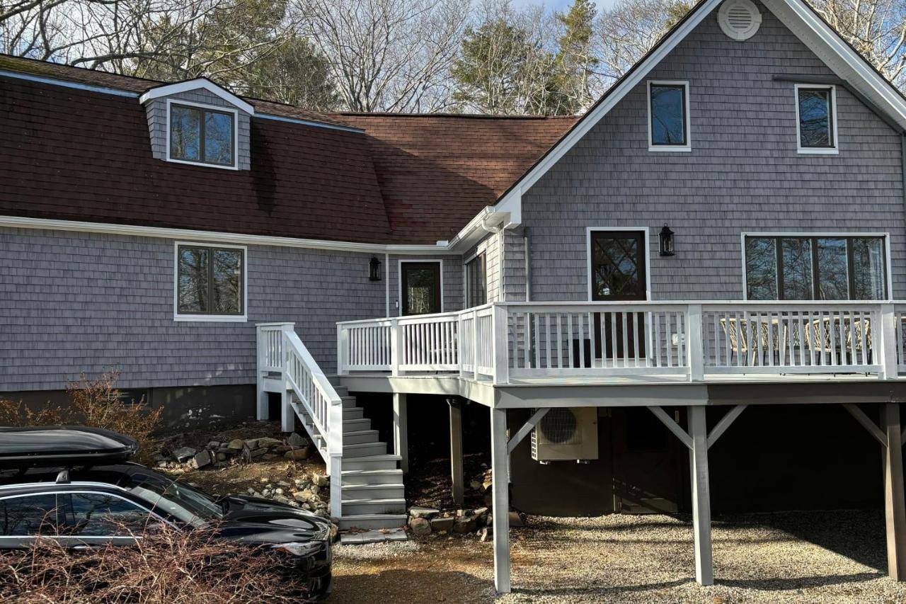 a house with a deck and a car in front of it at Willow Cove in York