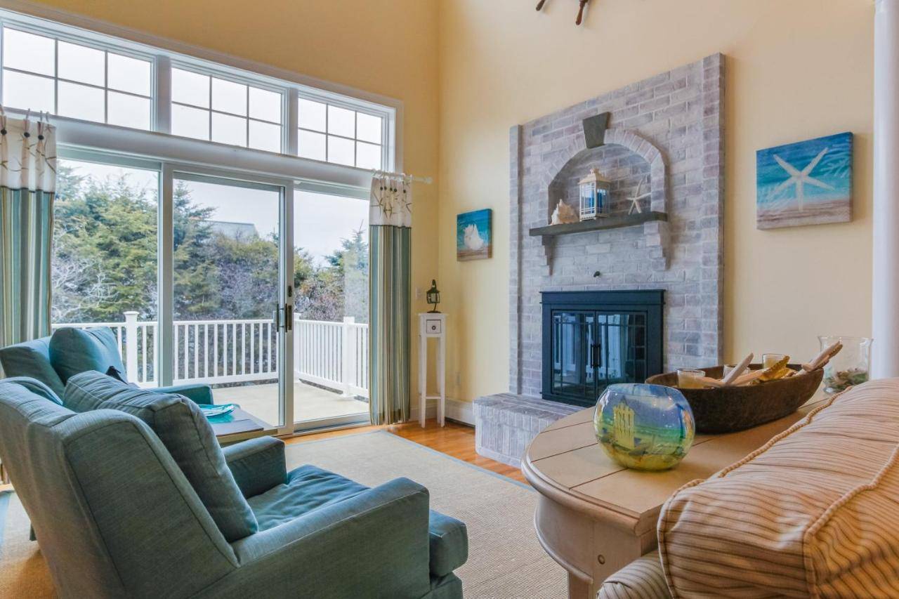 a living room with a couch and a fireplace at York Starfish Haven in York
